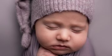Newborn baby lying peacefully, highlighting the importance of umbilical cord care.
