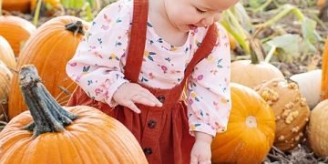 Happy baby sitting on a potty, representing success in potty training.