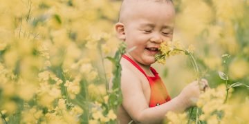 Child engaging in outdoor play to develop gross motor skills and coordination.