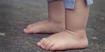 Toddler feet playing with colorful toys during engaging learning activities.