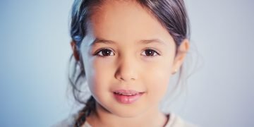 Young girl peacefully sleeping, highlighting the importance of healthy sleep patterns for kids.