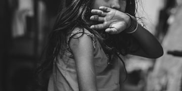 Young girl learning about effective strategies for managing childhood allergies.