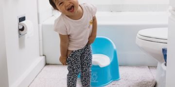 Toddler engaged in potty training, fostering resilience and independence in early childhood.