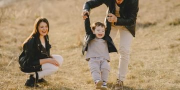 Father engaging in nurturing activities with children, emphasizing essential parenting tips.