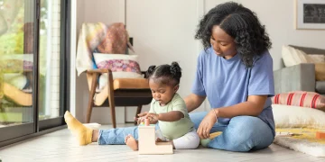 A joyful parent using a clever hack to simplify daily parenting tasks.