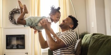 A diverse group of parents engaging in effective parenting strategies with children.