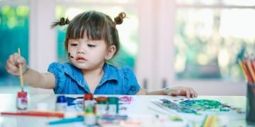 Toddler engaging in positive discipline activities, learning appropriate behavior through guidance.