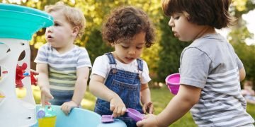 Toddlers making friends while developing essential social skills through play.