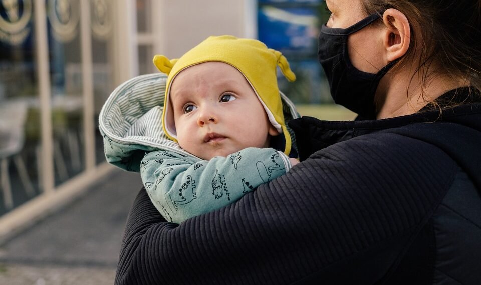 Mother nurturing her newborn, emphasizing healthy weight gain during early development.