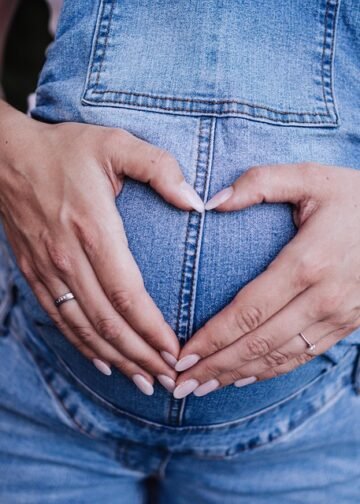 Expecting mom engaging in safe exercises during pregnancy for fitness and well-being.